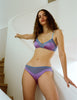 front shot lifestyle image of woman wearing purple and blue silk bra and panty 