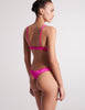 On model image of back of pink silk bra and pink silk panty