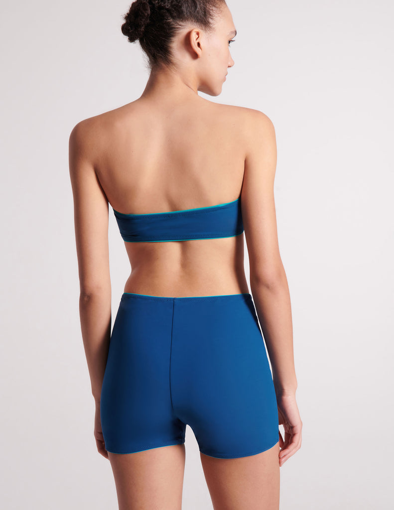 On model image of back of blue bandeau top and shorts 