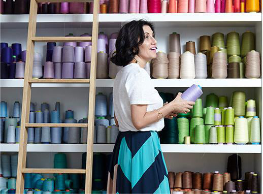 Araks in front of colorful shelves