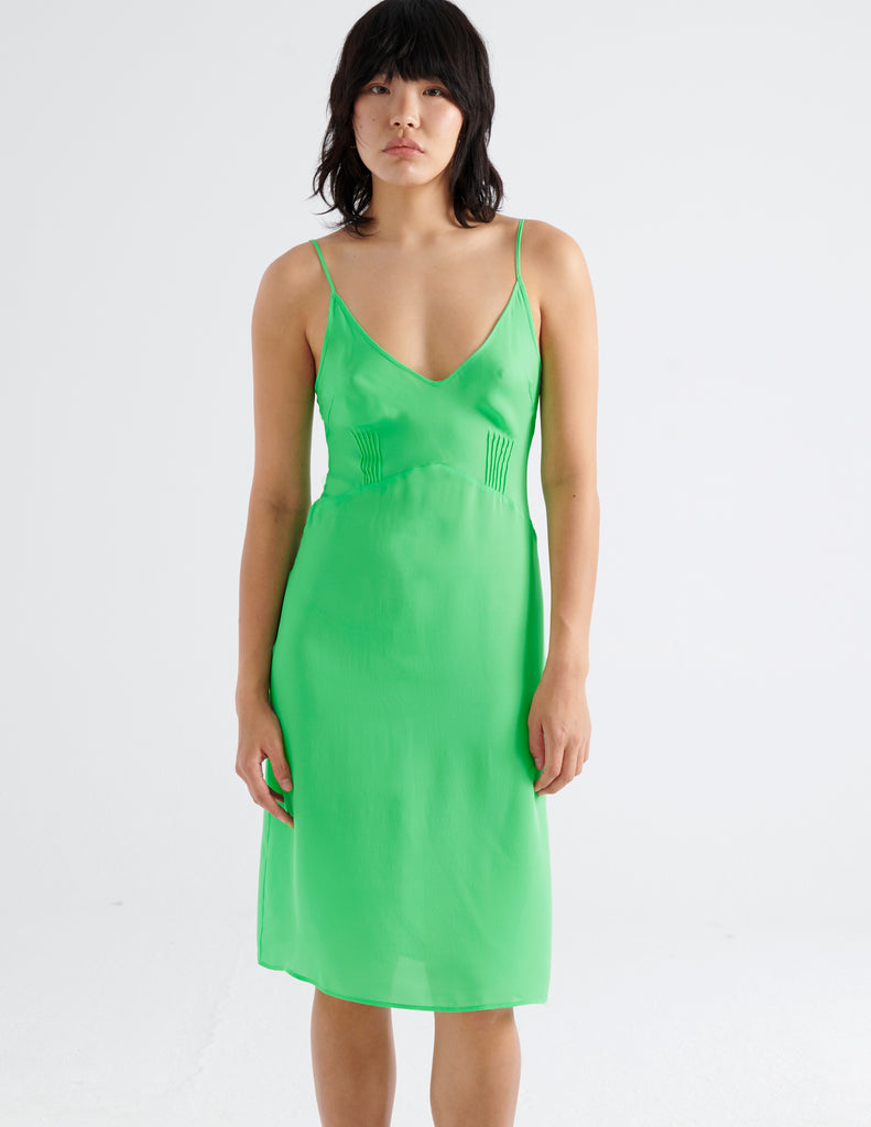The silk cadel slip in bright green worn on a model.