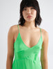 The silk cadel slip in bright green worn on a model.