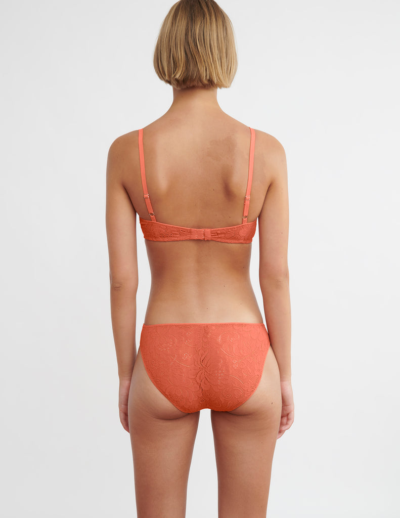 back view of woman in orange bra and panty